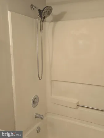 a white toilet sitting next to a bath tub and a shower
