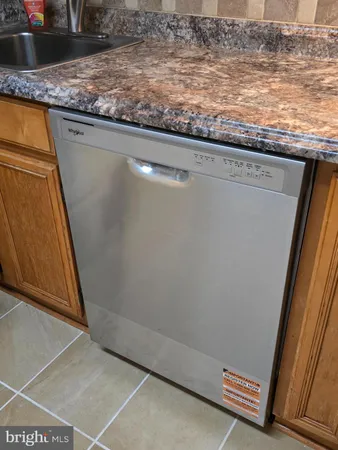 a kitchen with stainless steel appliances granite countertop a refrigerator a sink a stove a microwave and cabinets