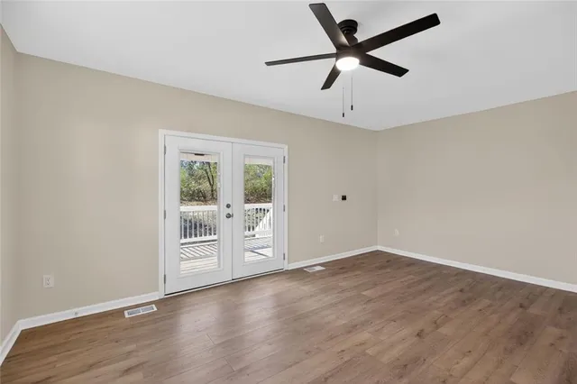 a view of a house with a yard and potted plants