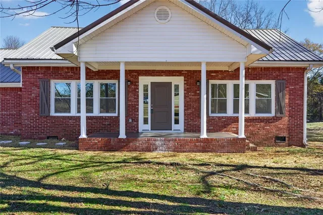 a kitchen with sink a stove and cabinets