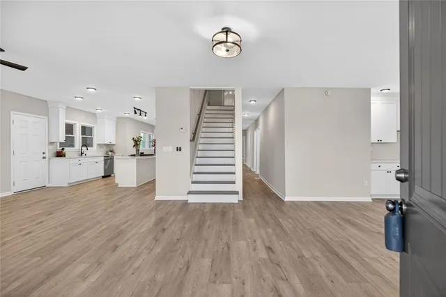 a kitchen that has a lot of cabinets a sink and appliances in it