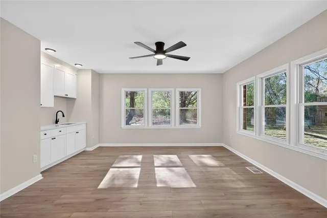 a view of a livingroom with a fireplace and a window