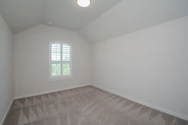 a bathroom with a granite countertop toilet sink and mirror
