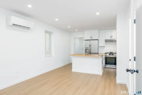 a kitchen with white cabinets and white appliances