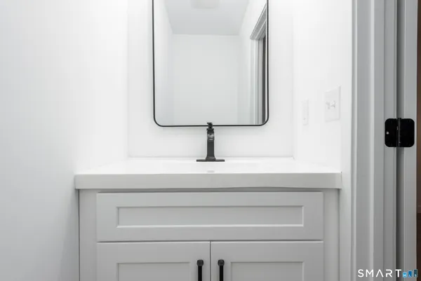 a bathroom with a sink and mirror