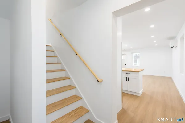 a view of entryway and hall with wooden floor