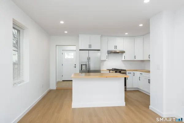 a kitchen with a stove a sink and a refrigerator