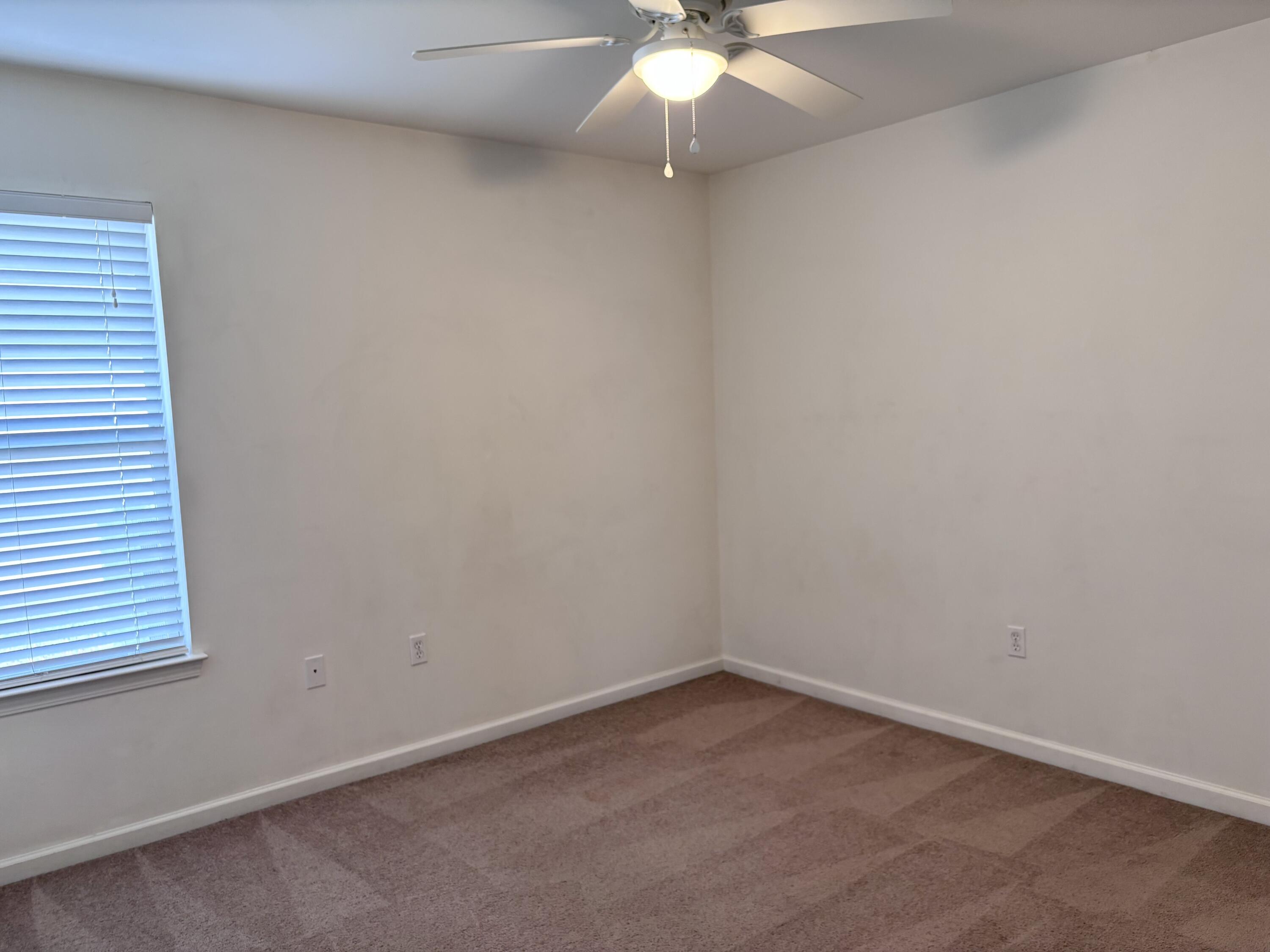 64 7th Street Shalimar, FL 32579 - Photo 11 of 16 an empty room with a window