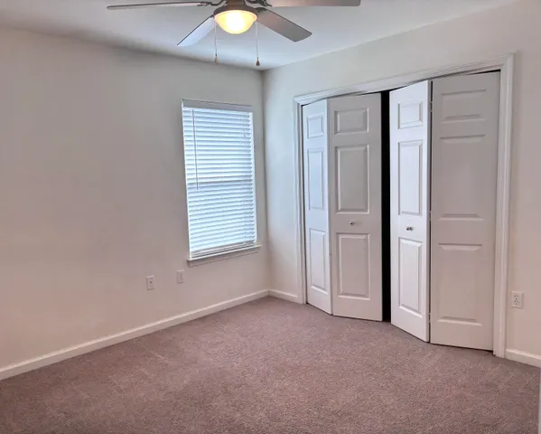 an empty room with windows and closet