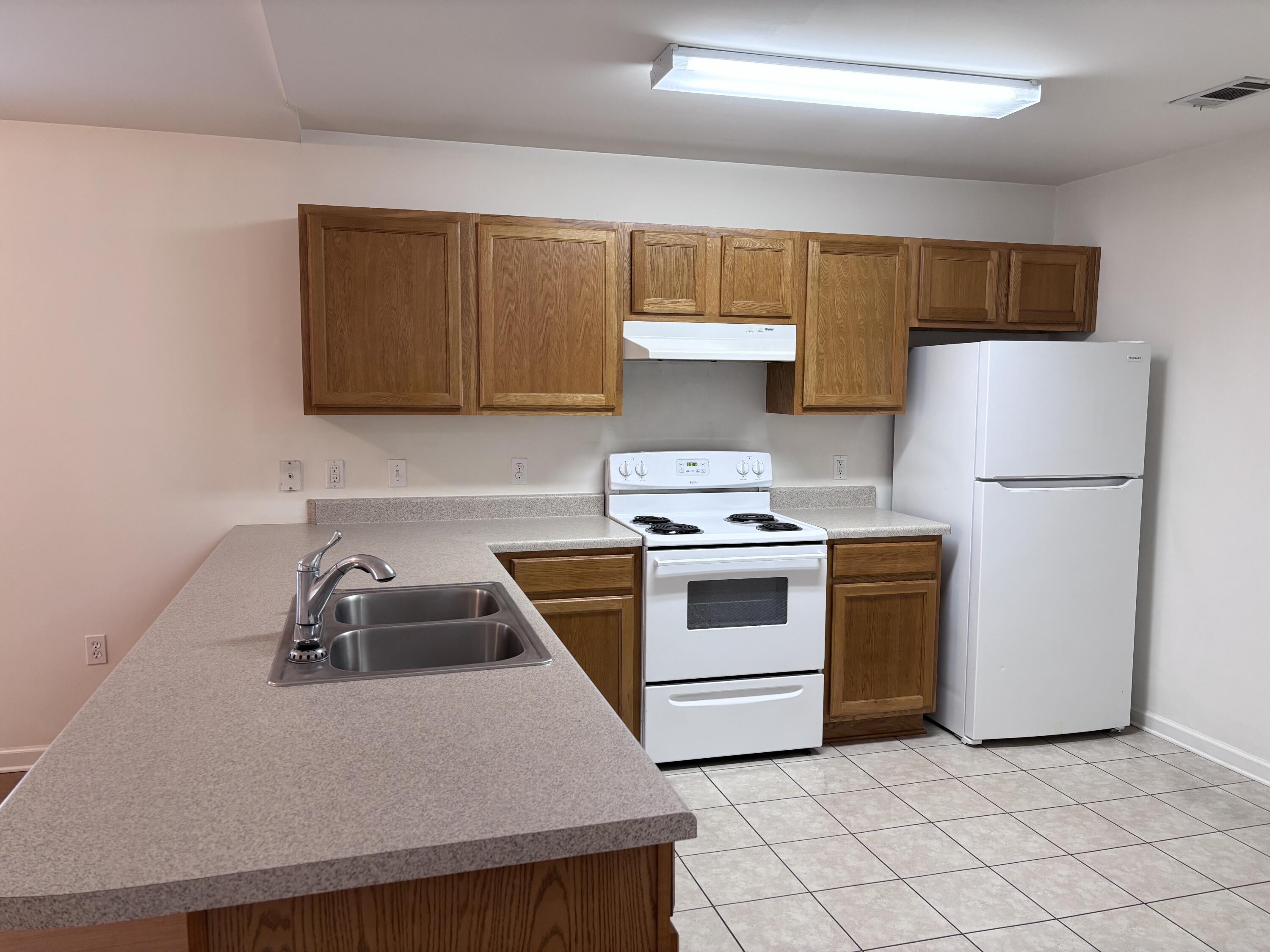 64 7th Street Shalimar, FL 32579 - Photo 5 of 16 a kitchen with a sink a stove and refrigerator