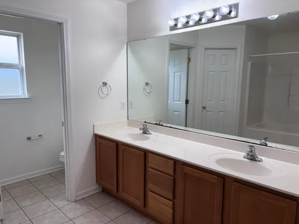 a bathroom with a sink vanity and mirror