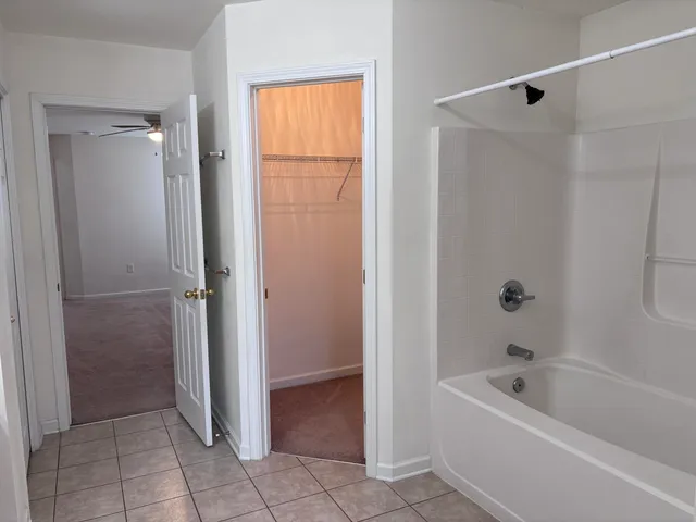 a bathroom with a tub shower and a sink
