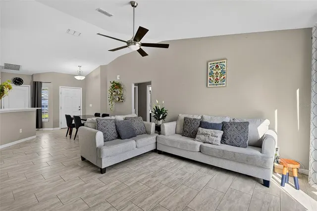 a living room with furniture and a wooden floor