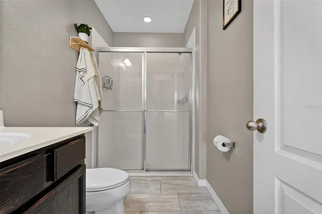 a bathroom with a shower a toilet and a sink