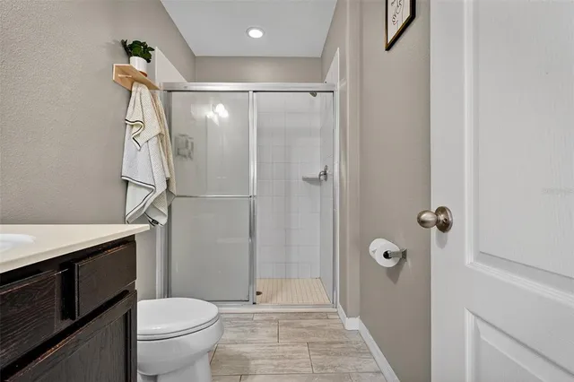 a bathroom with a shower a toilet and a sink