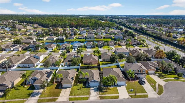 an aerial view of residential houses with outdoor space