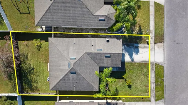 an aerial view of house with yard