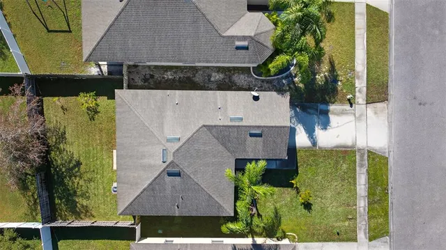 an aerial view of a house with a yard