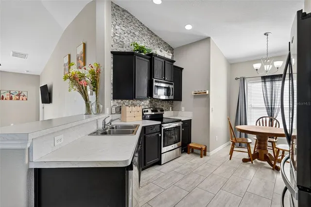a kitchen with a sink appliances and cabinets