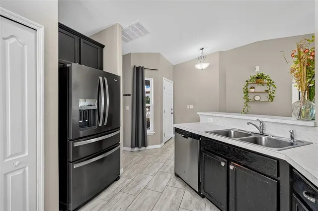 a kitchen with a refrigerator and a sink