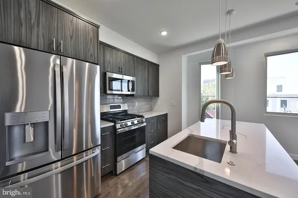 a kitchen with a refrigerator stove and sink