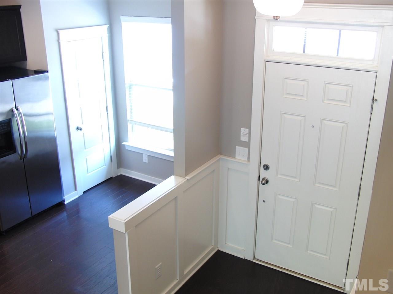 7893 Allscott Way Raleigh, NC 27612 - Photo 3 of 25 a view of an empty room with wooden floor and a window