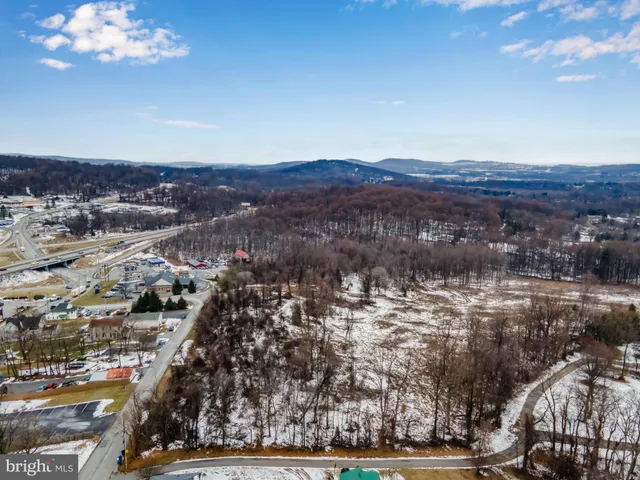 an aerial view of a house with a swimming pool yard and mountain view in back