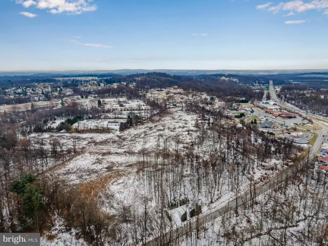 an aerial view of residential houses with city view