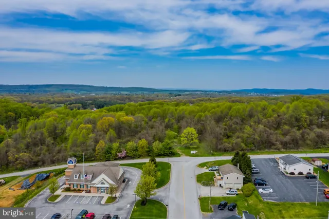 an aerial view of house with yard swimming pool and outdoor seating