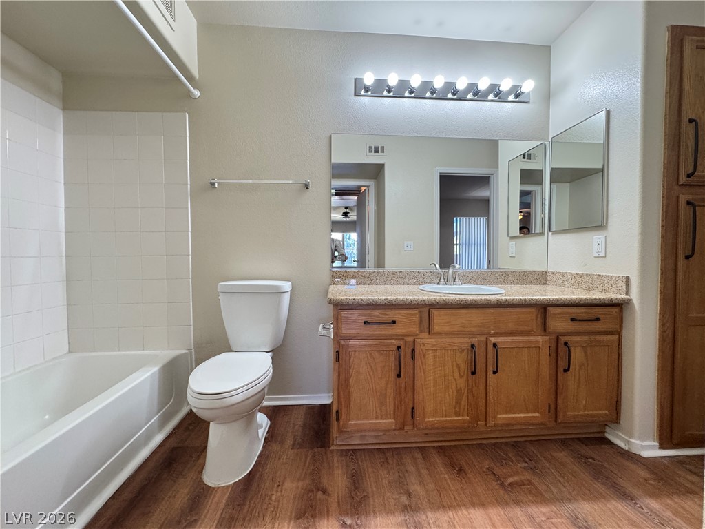 7255 West Sunset Road, Unit 2111 Las Vegas, NV 89113 - Photo 16 of 33 A well-appointed bath features rich wood cabinetry and ample vanity space.