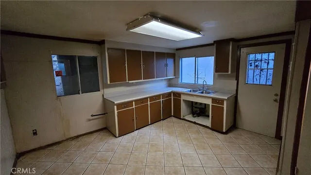 a kitchen with stainless steel appliances granite countertop a stove a refrigerator and a cabinets