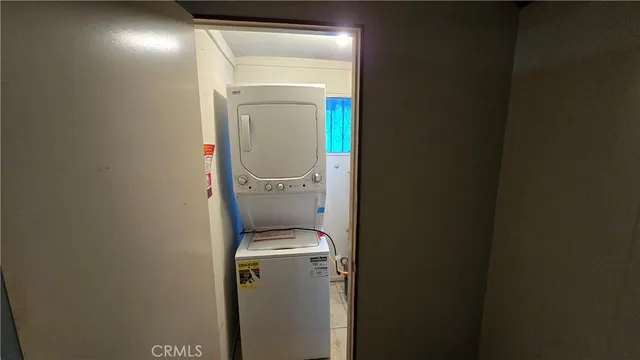 a view of a small space with wooden floor and a window