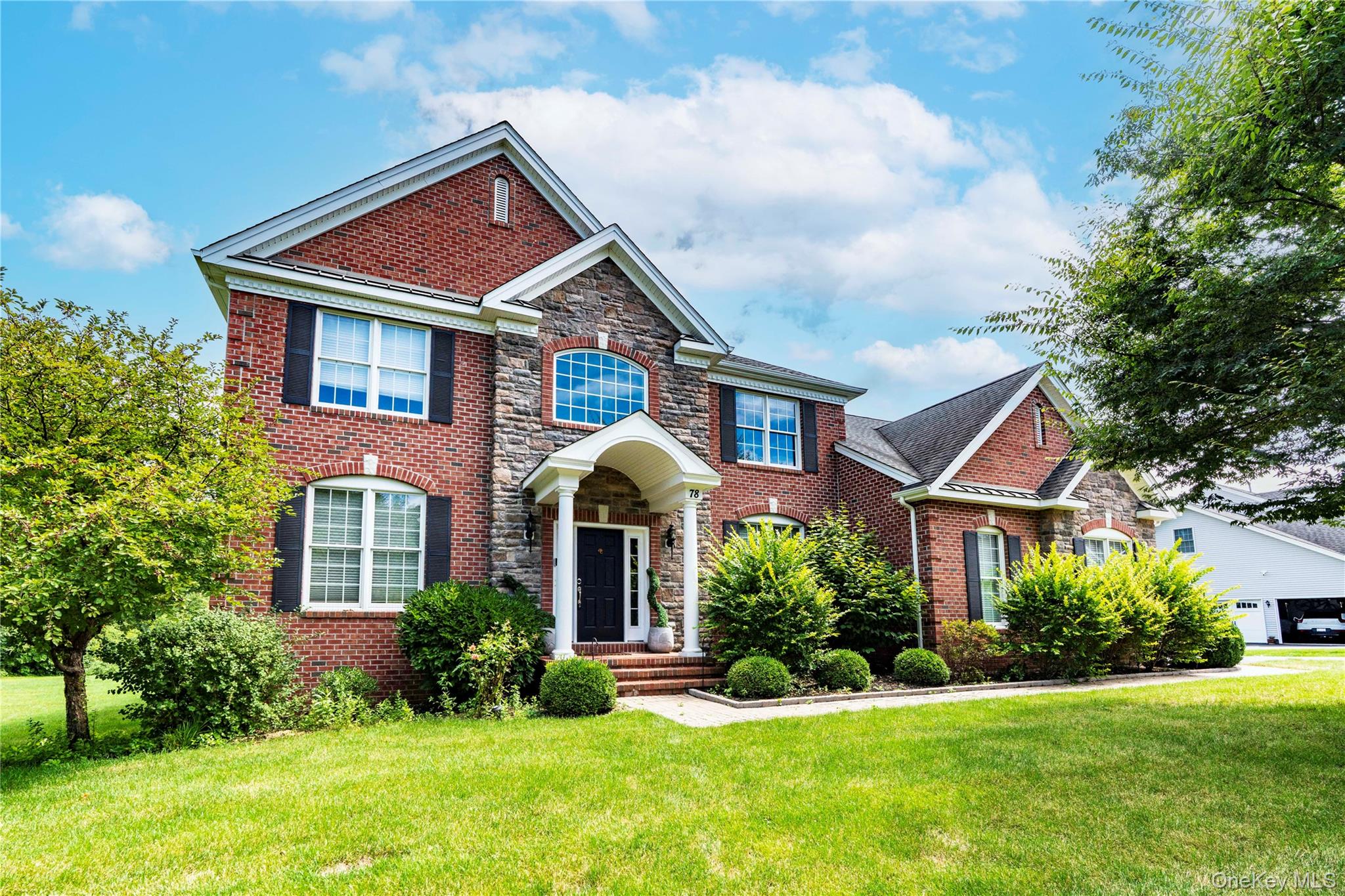 78 Moore Road Hopewell Junction, NY 12533 - Photo 1 of 38 View of front of property featuring brick siding, a front lawn, and stone siding