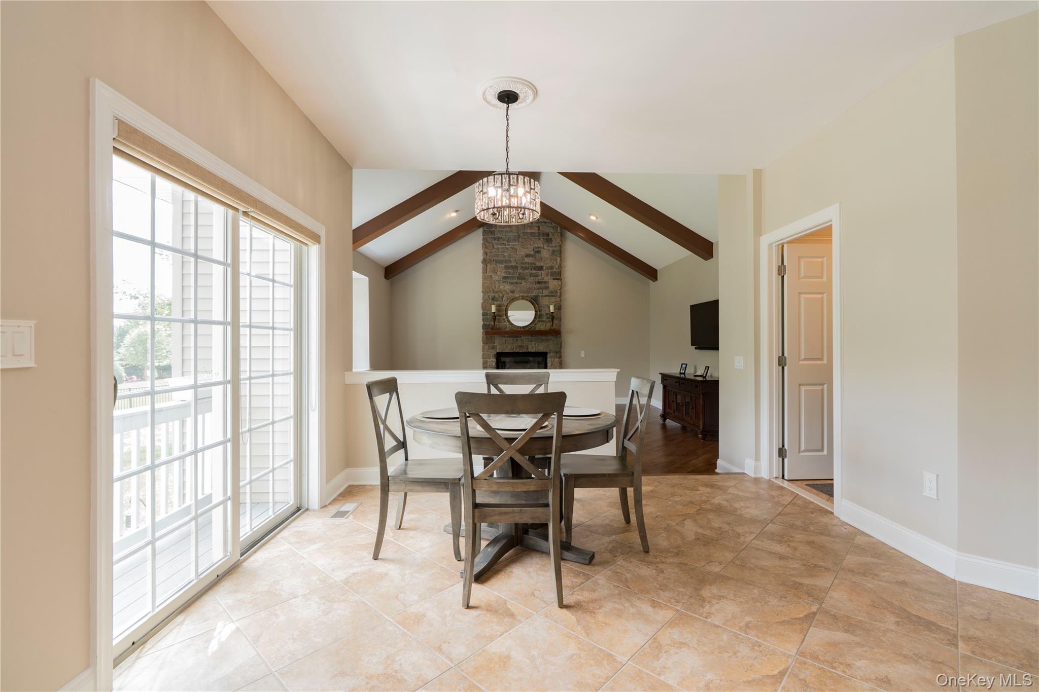 78 Moore Road Hopewell Junction, NY 12533 - Photo 17 of 38 Dining space featuring a chandelier and light tile patterned floors