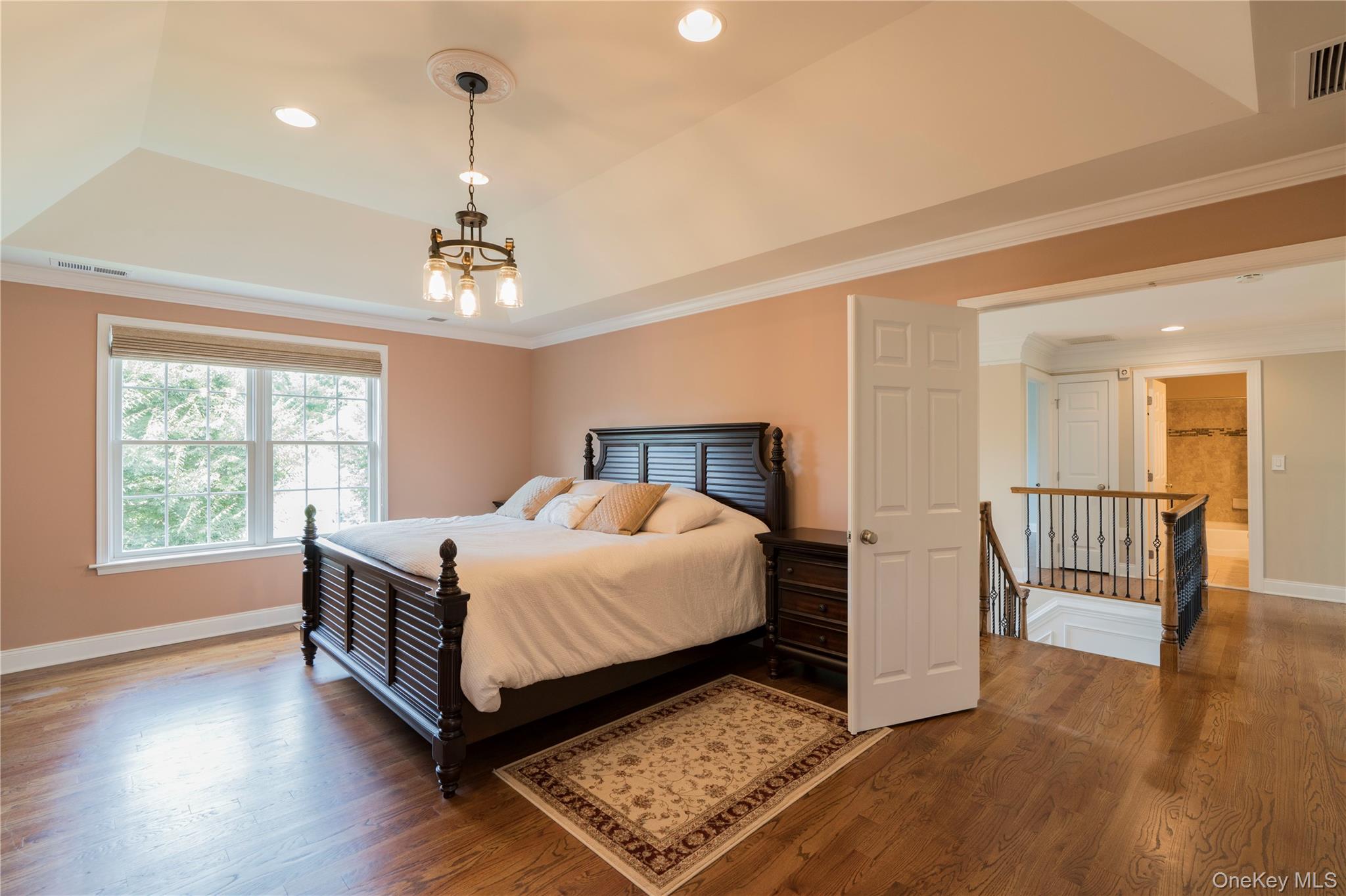 78 Moore Road Hopewell Junction, NY 12533 - Photo 23 of 38 Bedroom featuring a tray ceiling, recessed lighting, wood finished floors, and ornamental molding