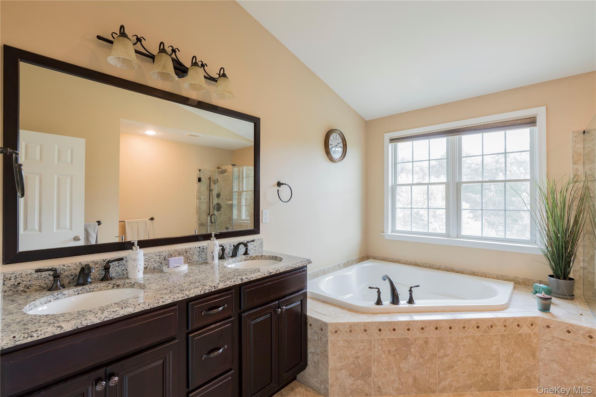 78 Moore Road Hopewell Junction, NY 12533 - Photo 26 of 38 Bathroom featuring a shower stall, a garden tub, double vanity, and lofted ceiling