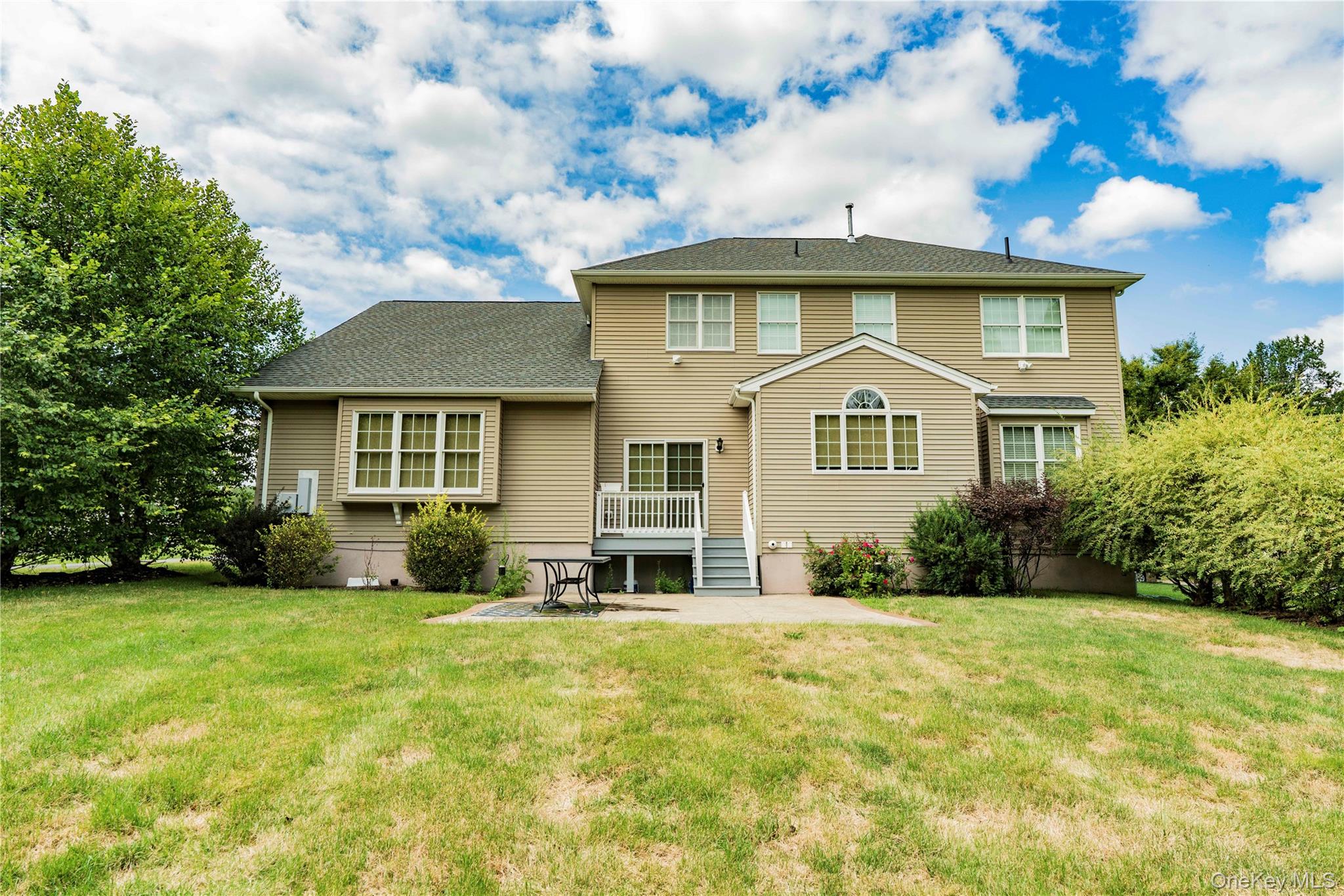 78 Moore Road Hopewell Junction, NY 12533 - Photo 35 of 38 Back of property with a patio area, a yard, and a wooden deck