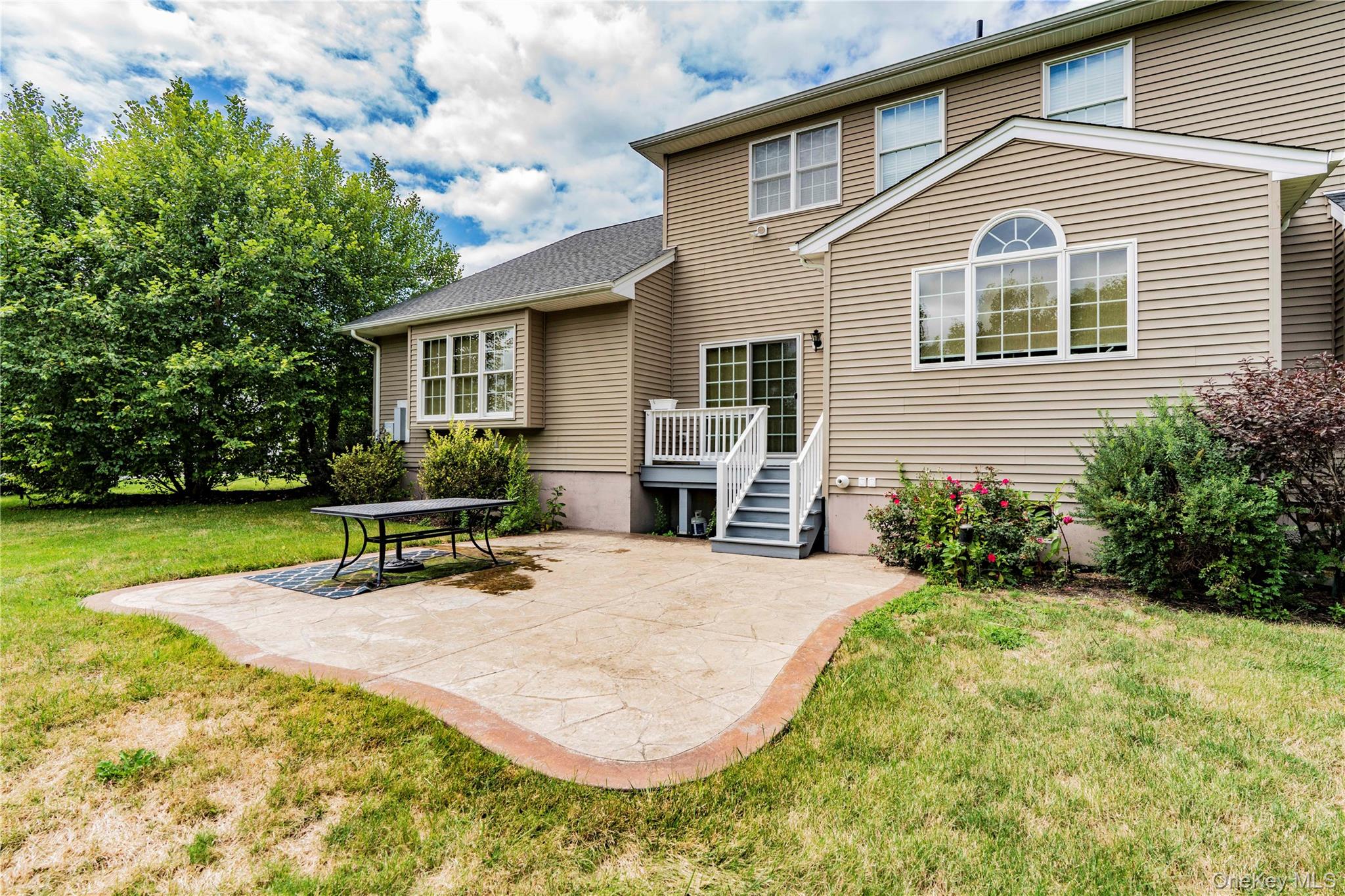 78 Moore Road Hopewell Junction, NY 12533 - Photo 36 of 38 Rear view of house with a patio and a lawn