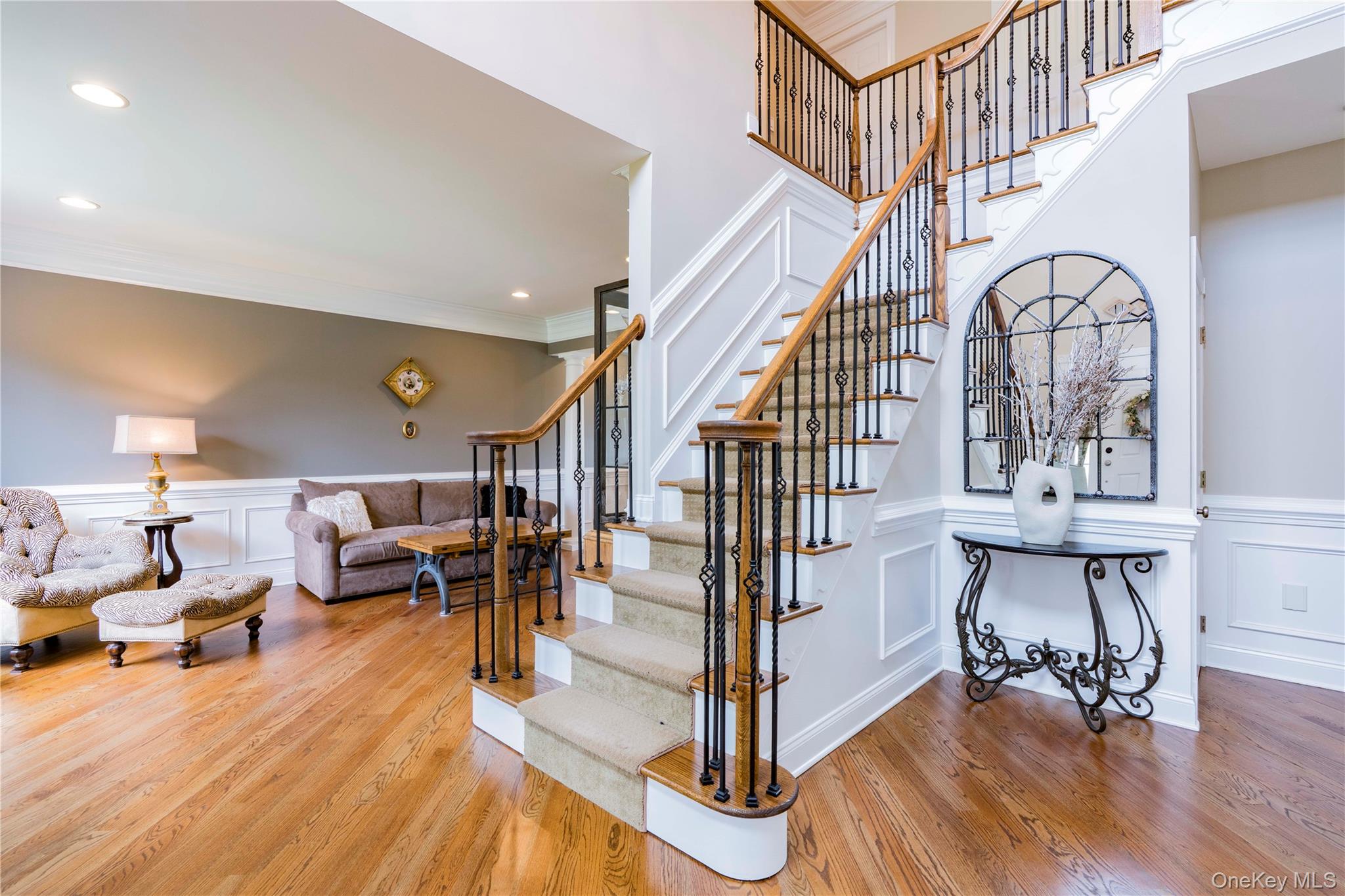 78 Moore Road Hopewell Junction, NY 12533 - Photo 4 of 38 Stairway featuring a decorative wall, a wainscoted wall, wood finished floors, and crown molding