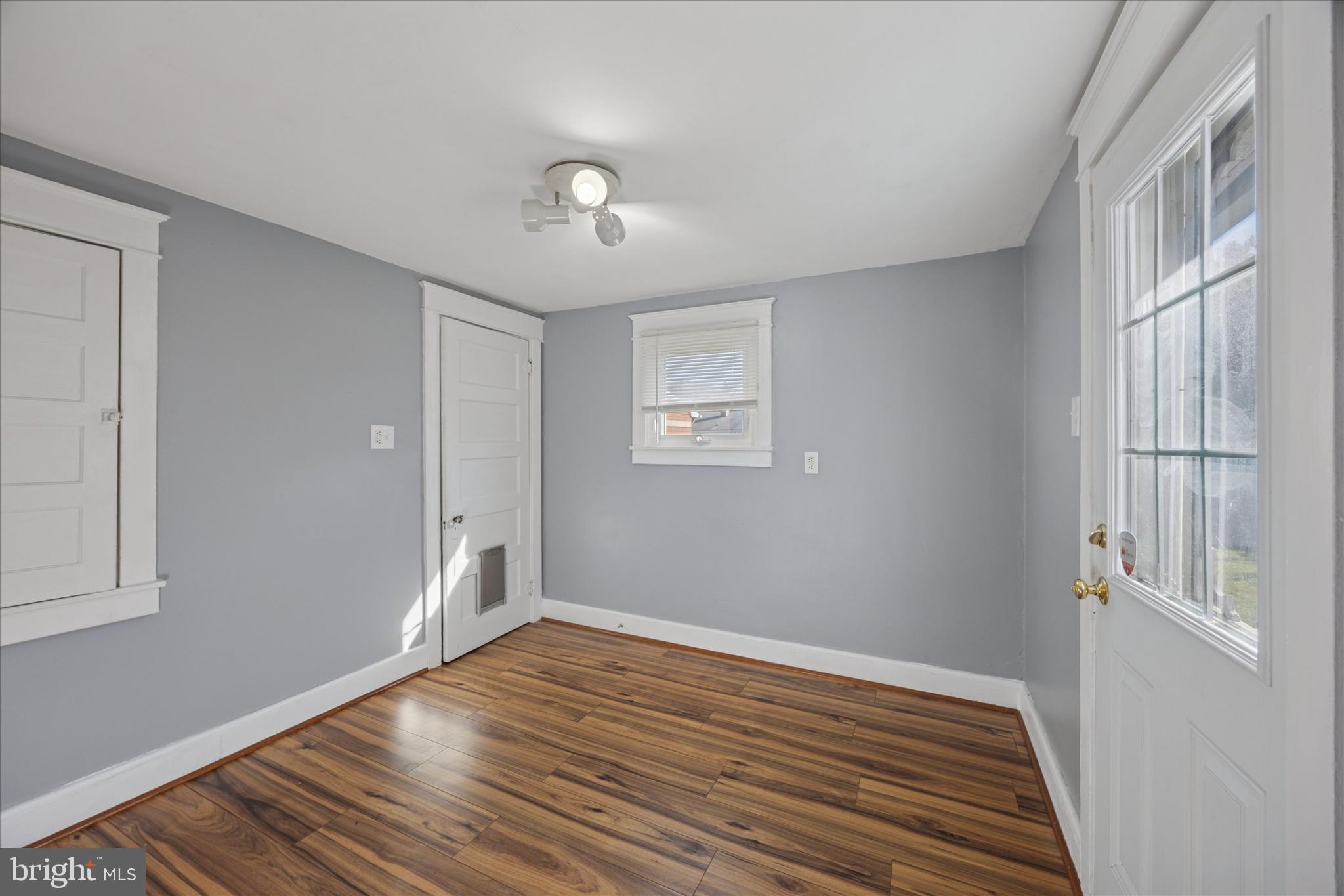 1035 Langley Street Trainer, PA 19061 - Photo 6 of 16 a view of an empty room with wooden floor and a window