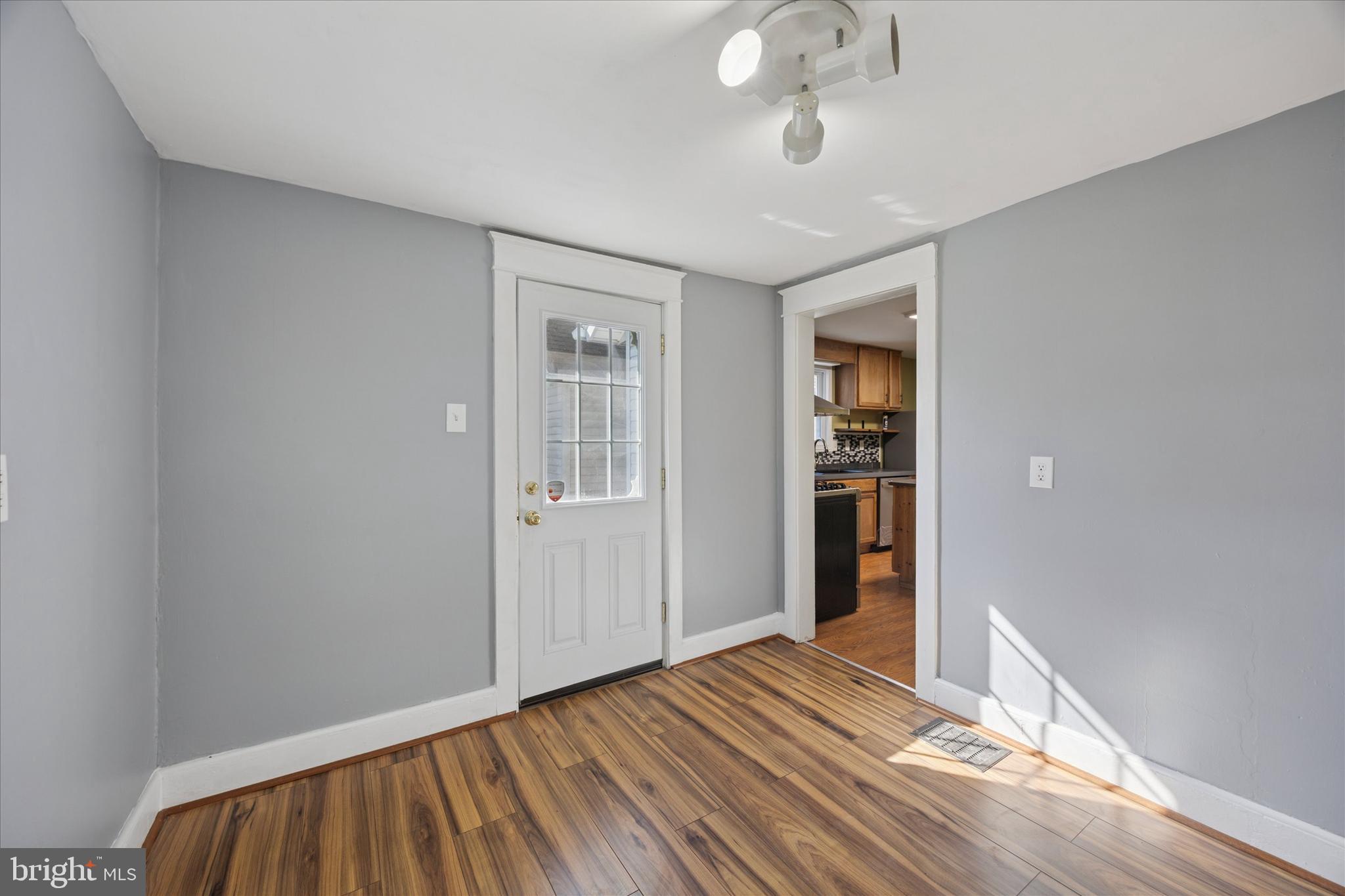 1035 Langley Street Trainer, PA 19061 - Photo 7 of 16 wooden floor in an empty room with a window