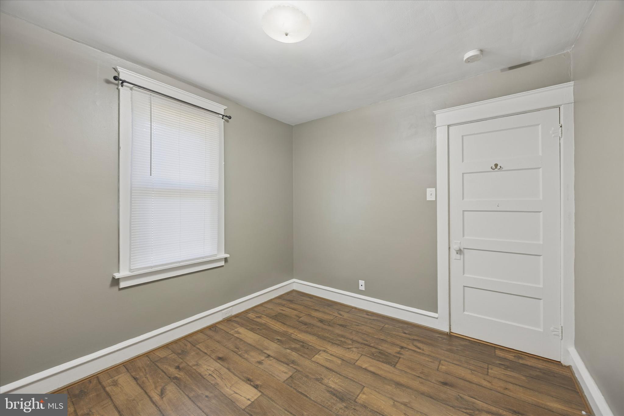1035 Langley Street Trainer, PA 19061 - Photo 9 of 16 a view of an empty room with wooden floor and a window