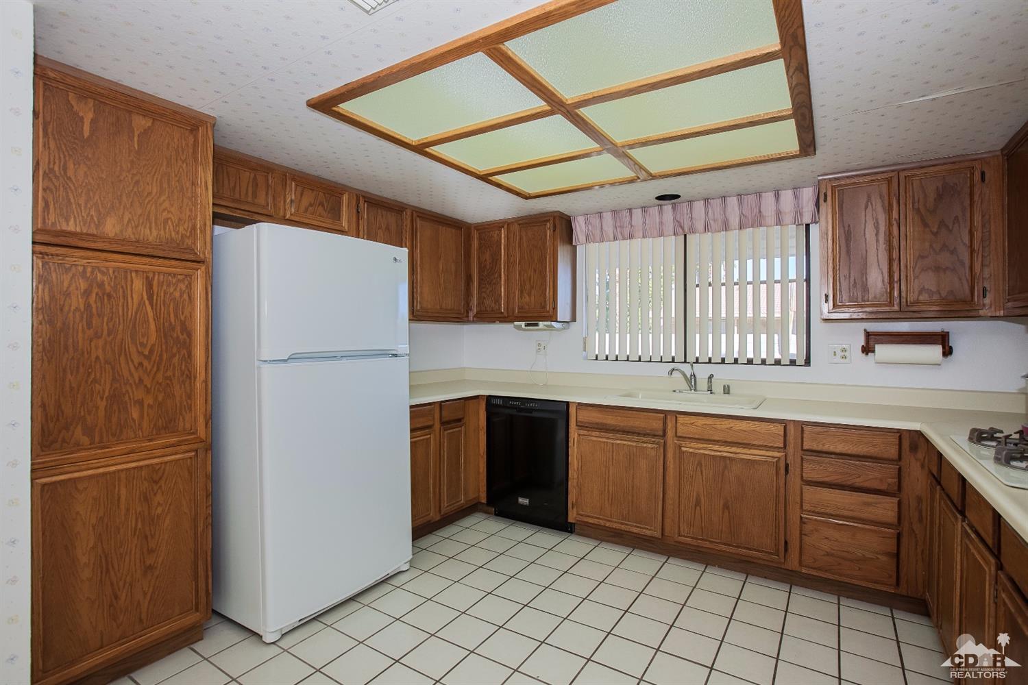 68640 Los Gatos Road Cathedral City, CA 92234 - Photo 11 of 33 a kitchen with stainless steel appliances granite countertop a refrigerator and a sink