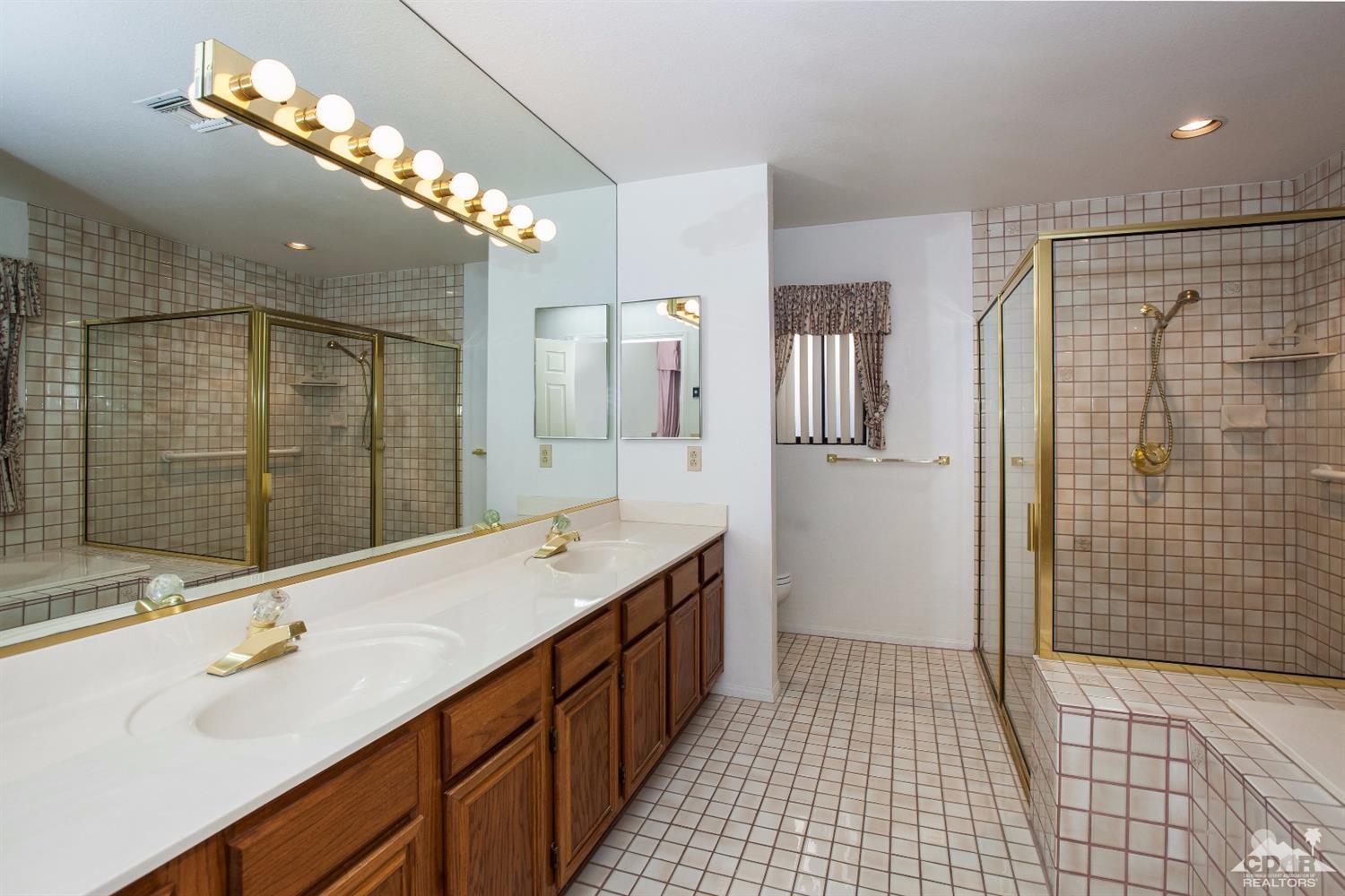 68640 Los Gatos Road Cathedral City, CA 92234 - Photo 21 of 33 a bathroom with a double vanity sink mirror and shower