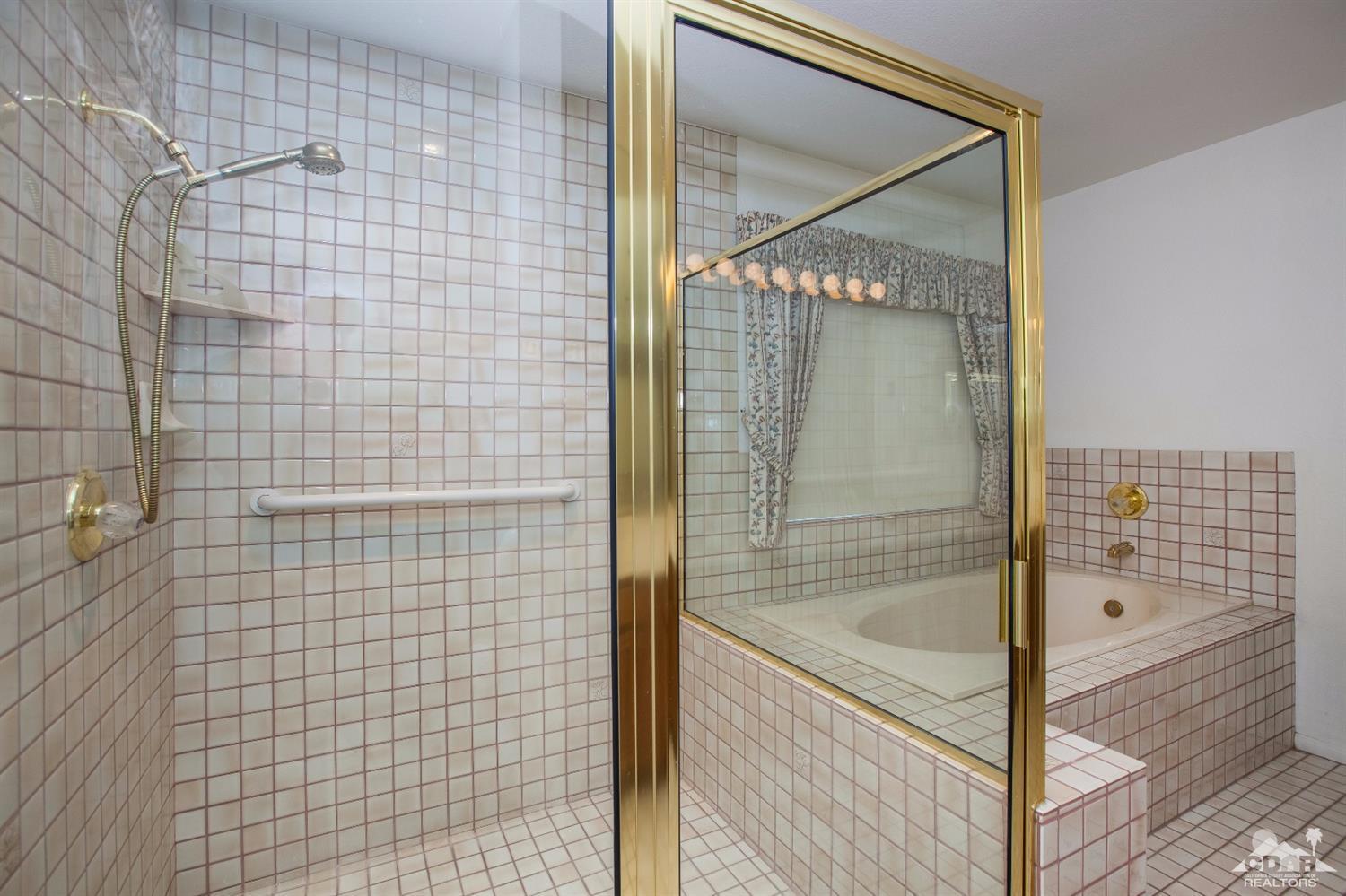 68640 Los Gatos Road Cathedral City, CA 92234 - Photo 22 of 33 a bathroom with a glass shower door
