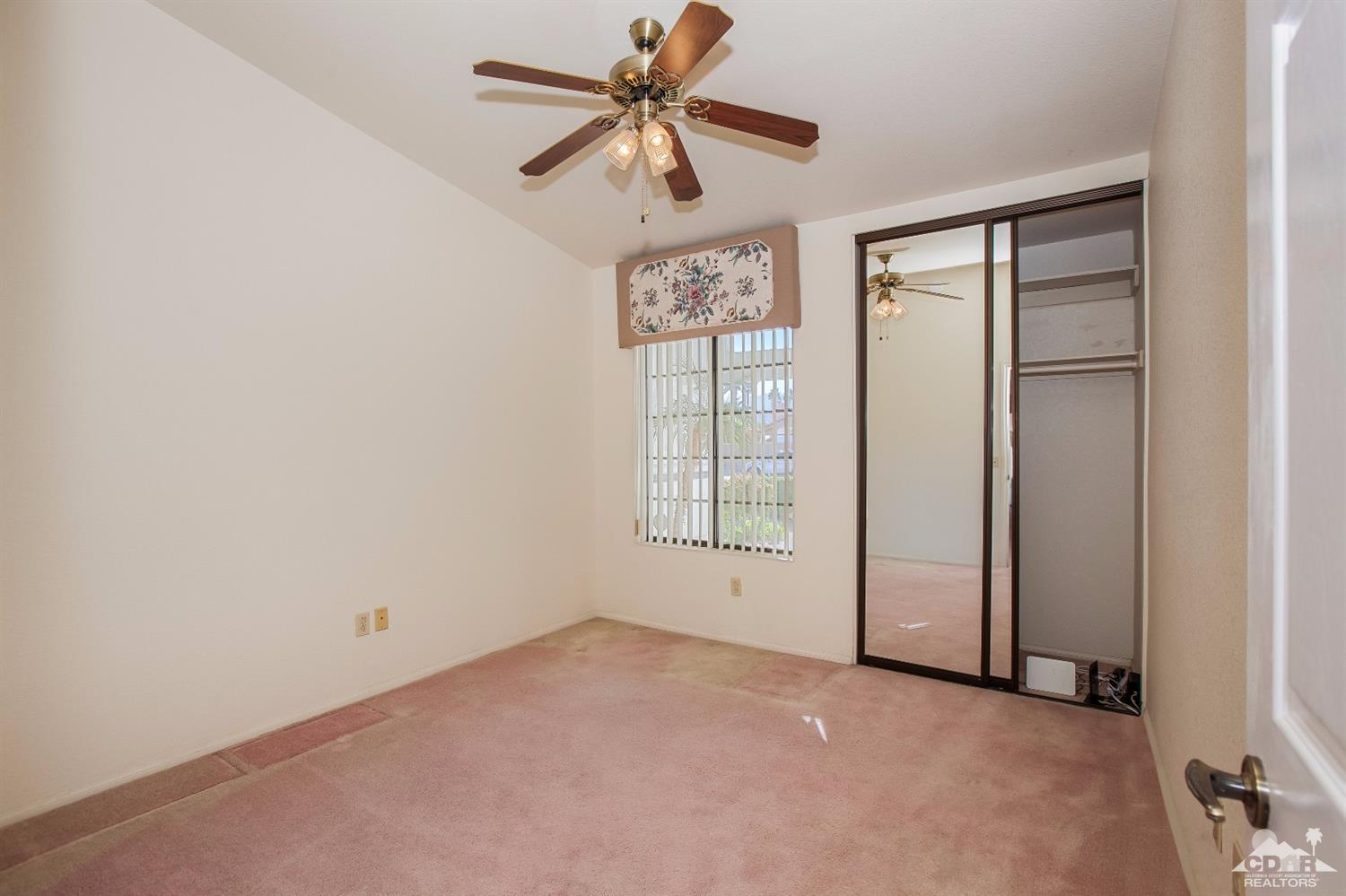 68640 Los Gatos Road Cathedral City, CA 92234 - Photo 27 of 33 an empty room with windows and fan