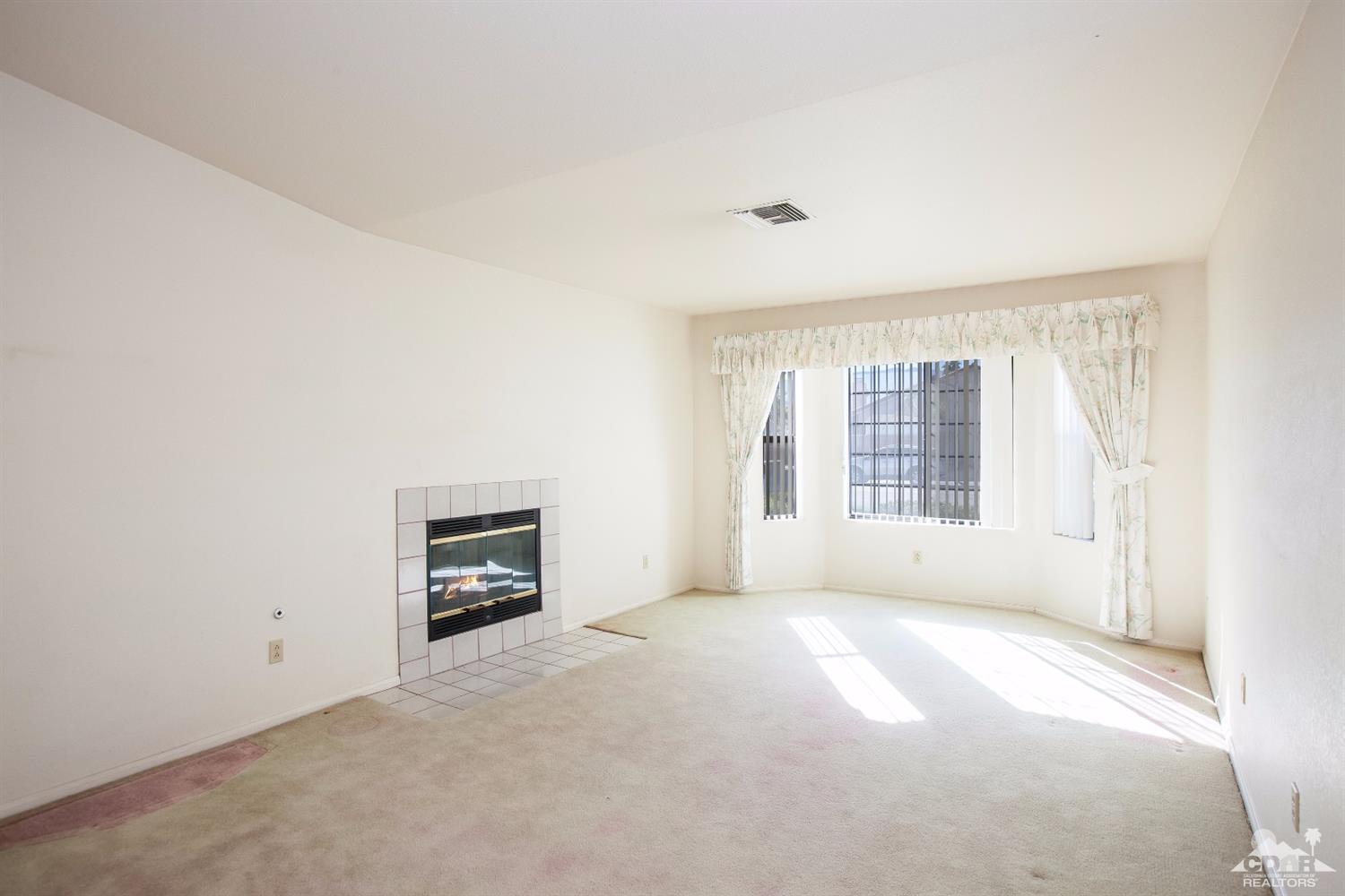 68640 Los Gatos Road Cathedral City, CA 92234 - Photo 6 of 33 a view of an empty room with a window and a kitchen