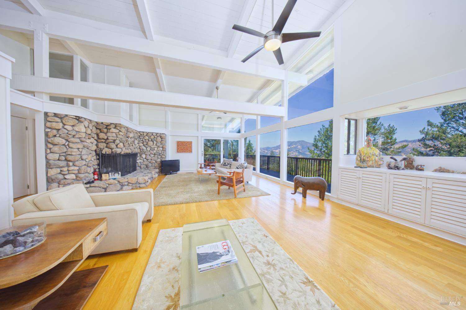 1755 Diamond Mountain Road Calistoga, CA 94515 - Photo 12 of 67 a living room with fireplace furniture and a floor to ceiling window
