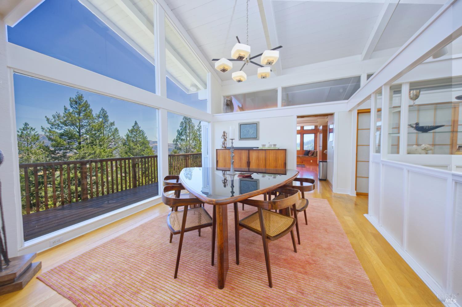 1755 Diamond Mountain Road Calistoga, CA 94515 - Photo 14 of 67 a dining room with furniture a rug and wooden floor