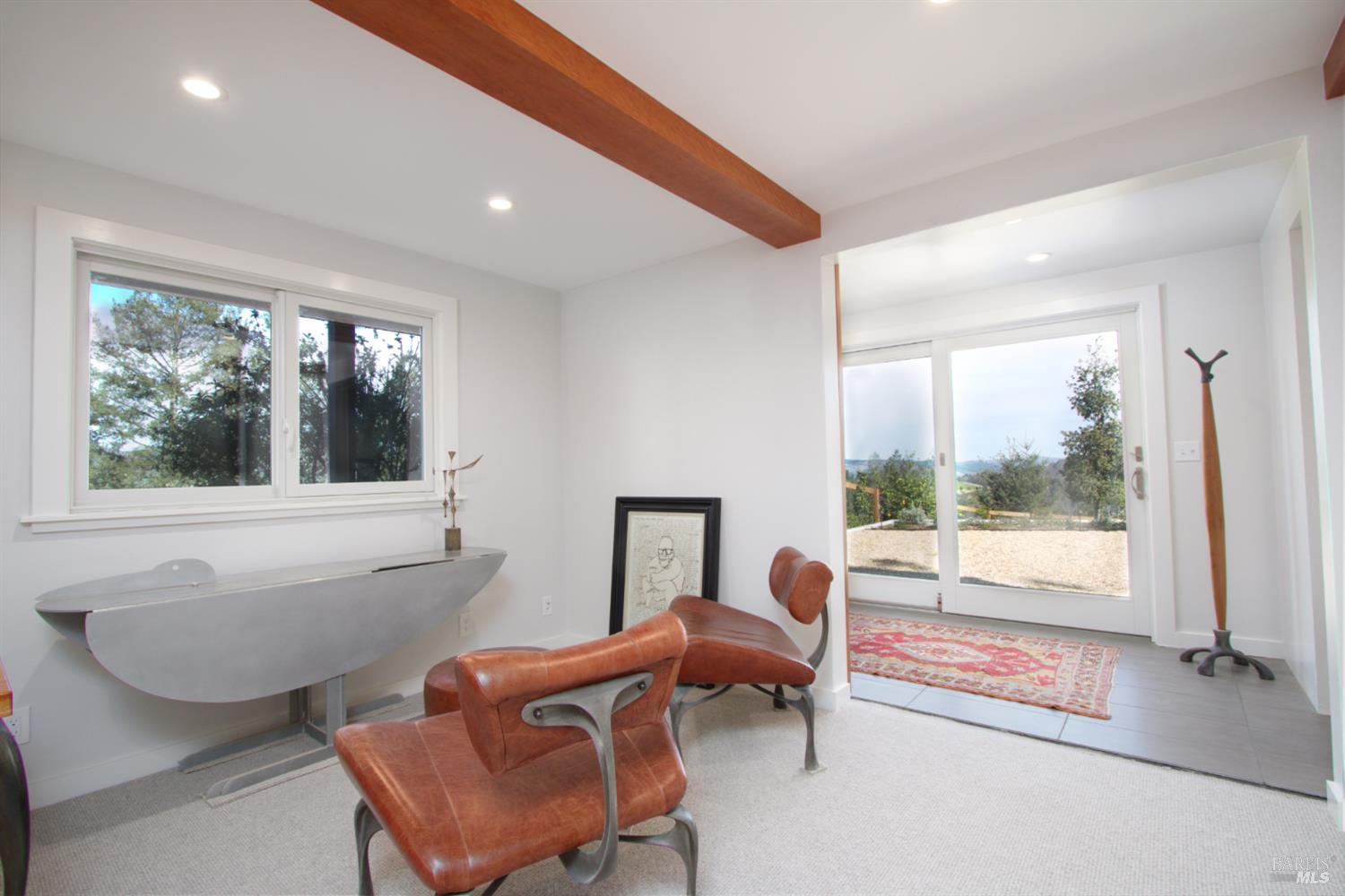 1755 Diamond Mountain Road Calistoga, CA 94515 - Photo 20 of 67 a living room with furniture and a floor to ceiling window